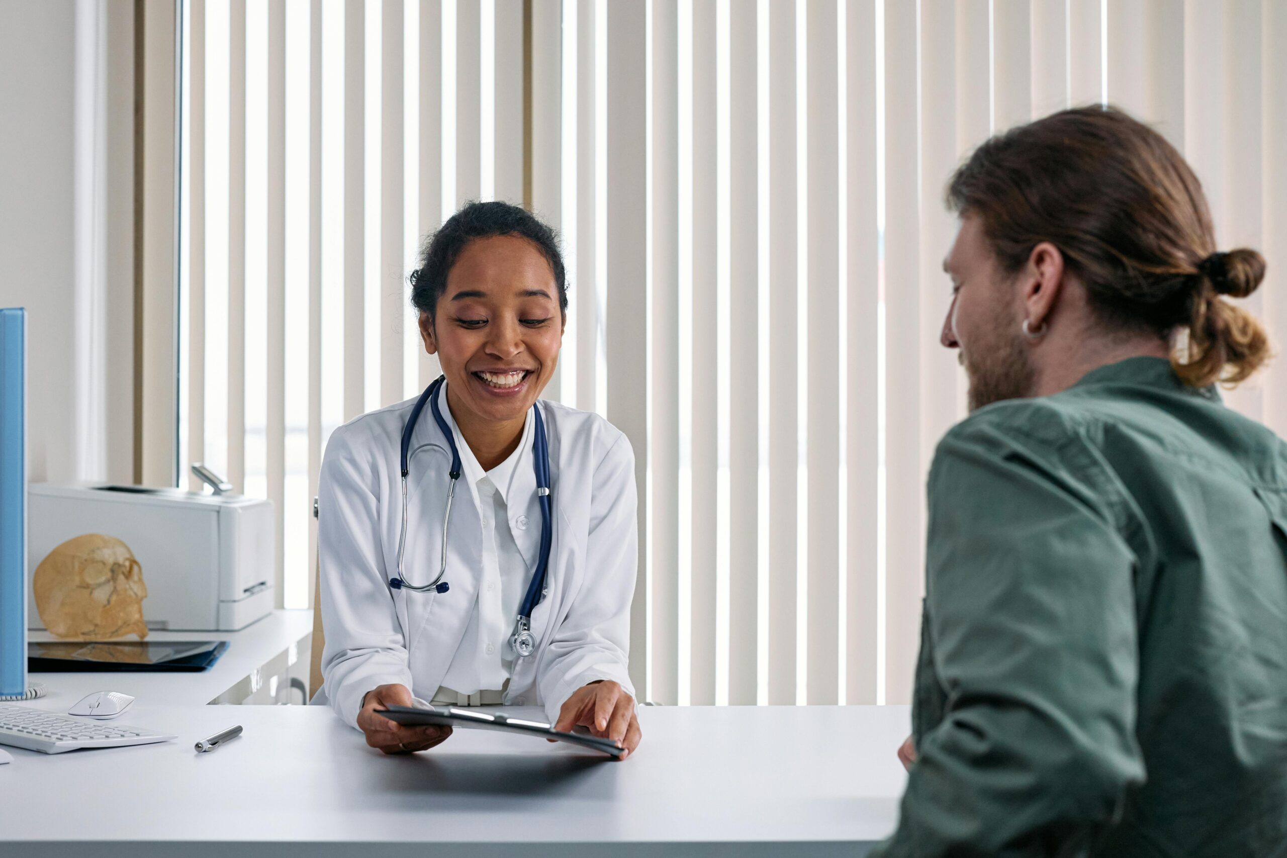 Home A doctor and patient engaging in a positive consultation in a bright clinic setting.